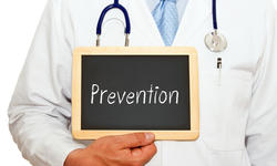 Prevention - Doctor with chalkboard and text on wh